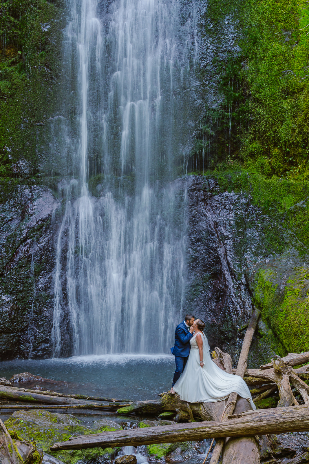 Couple kisses at the base of Marymere Falls in Olympic National Park