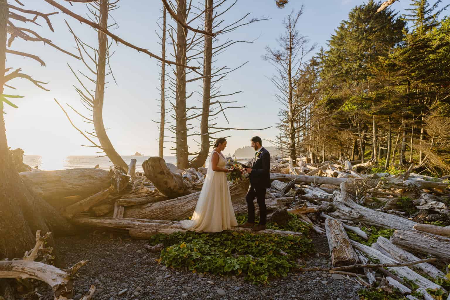 Couple says their adventure elopement vows on Rialto Beach in Olympic National Park at sunset