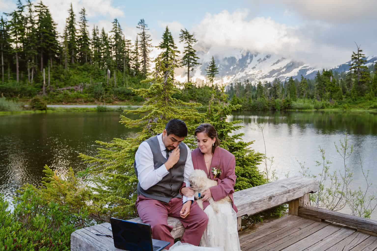 Couple watches videos from family members during their elopement at Picture Lake in Mount Baker Wilderness
